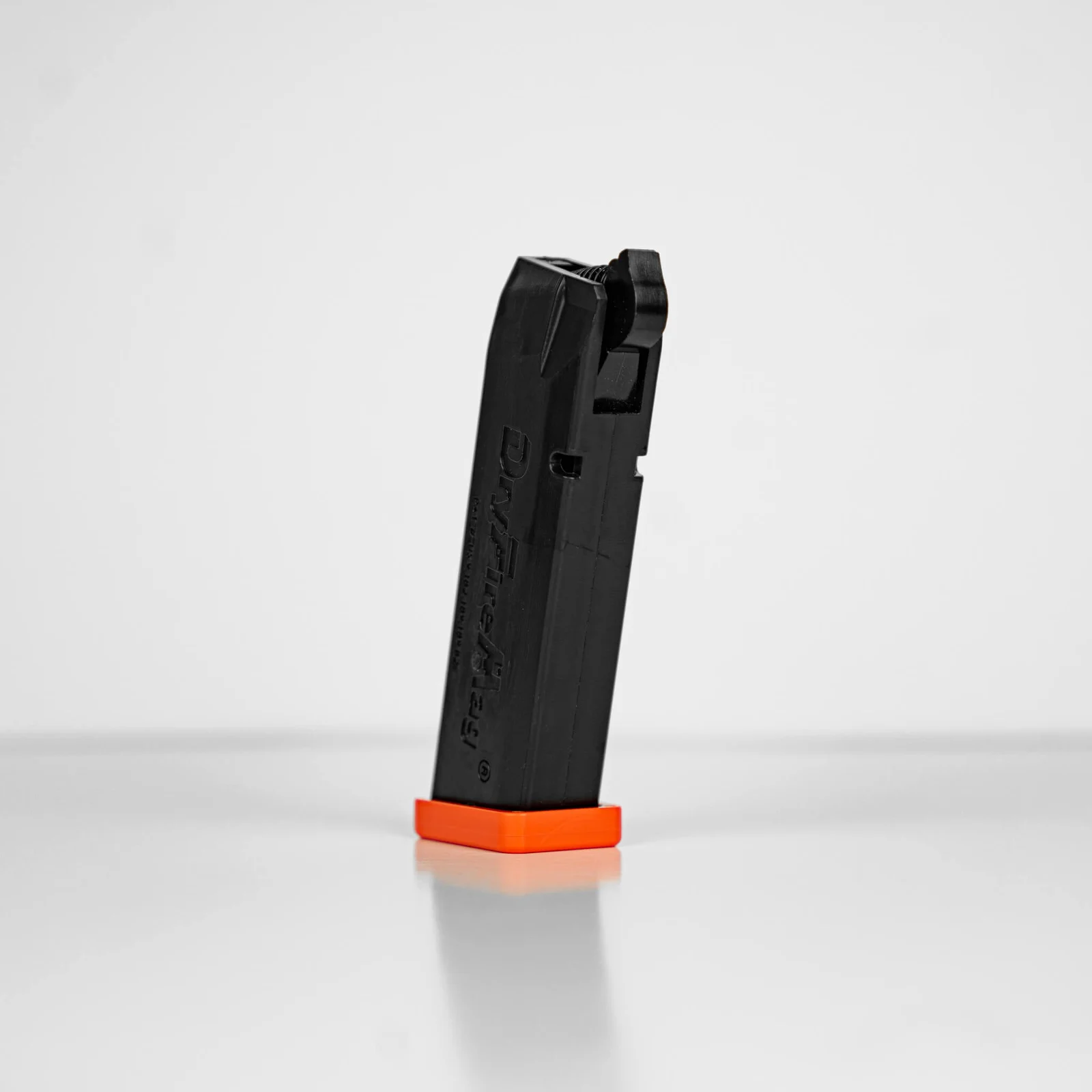 DryFireMag training magazine with an orange baseplate on a white background
