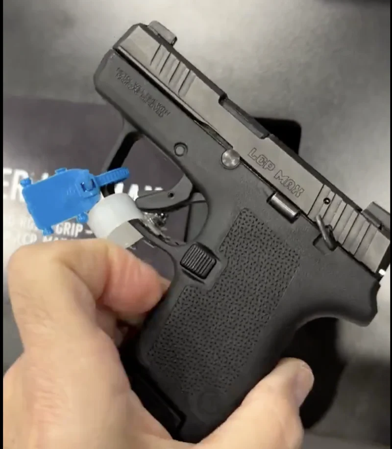 Side profile of the Ruger LCP MAX with the Magpul EHG RG380 grip module installed, LCP MAX engraved on the slide and the product box visible in the background