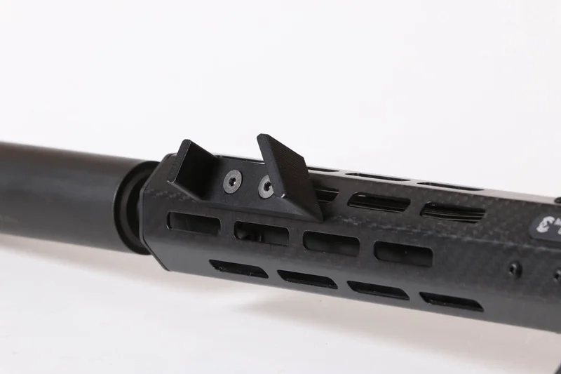 A thumb rest and barricade stop mounted on a modern M-LOK AR-15 handguard