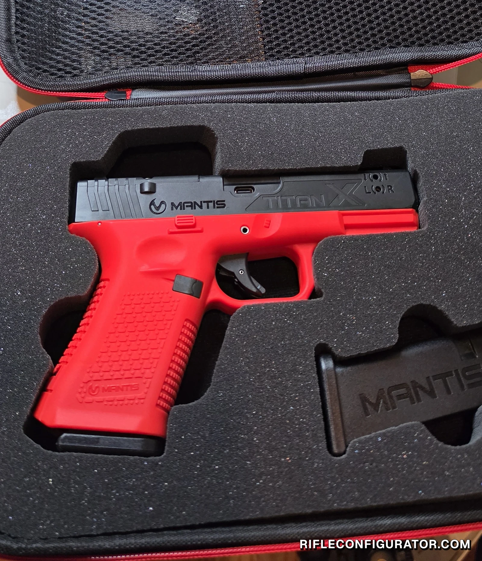 Mantis TitanX Glock 19 version in its foam-lined EVA case with a weighted magazine beside it and the lid's mesh pocket above