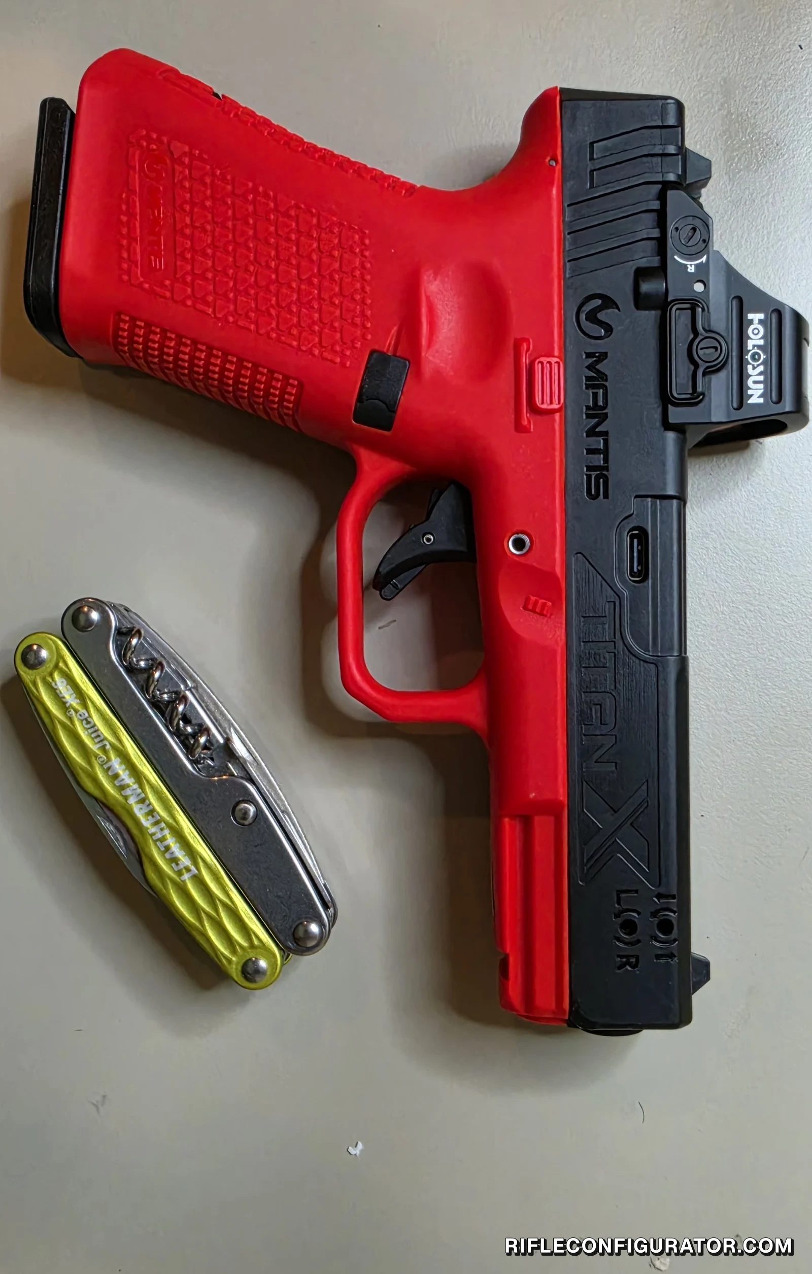 Mantis TitanX Glock 19 version with a Holosun 507C ACSS red dot mounted on the slide's optic cut, shown beside a Leatherman Juice multitool for scale