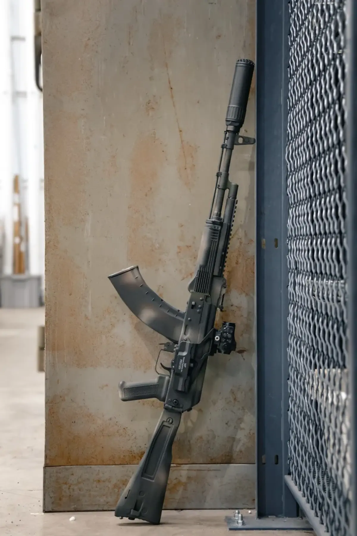 Meridian Defense Trench-103 rifle in Midnight Varan Cerakote showing the black-dominant camouflage pattern across the full length of the rifle with the folding stock deployed