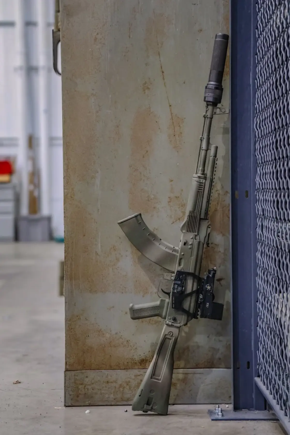 Meridian Defense Trench-103 rifle in Steppe Ghost Cerakote showing the folding stock, UltiMAK gas tube rail, and hand-painted grassland-blend disruption pattern