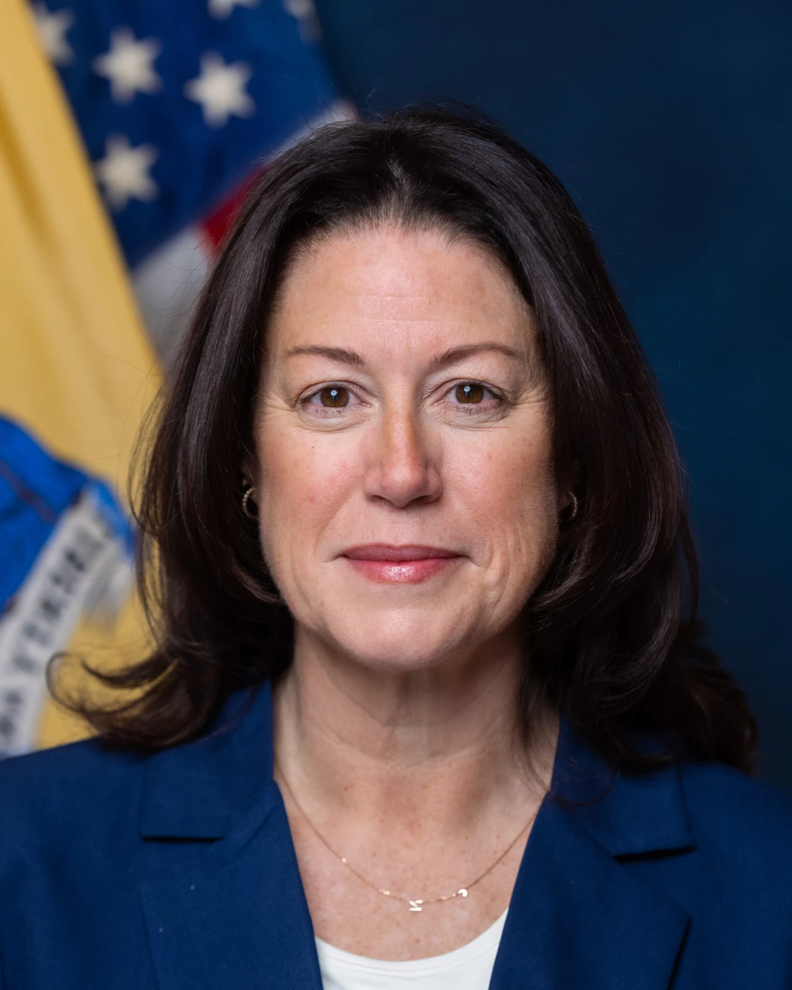 Official portrait of New Jersey Attorney General Jennifer Davenport in front of the New Jersey and United States flags