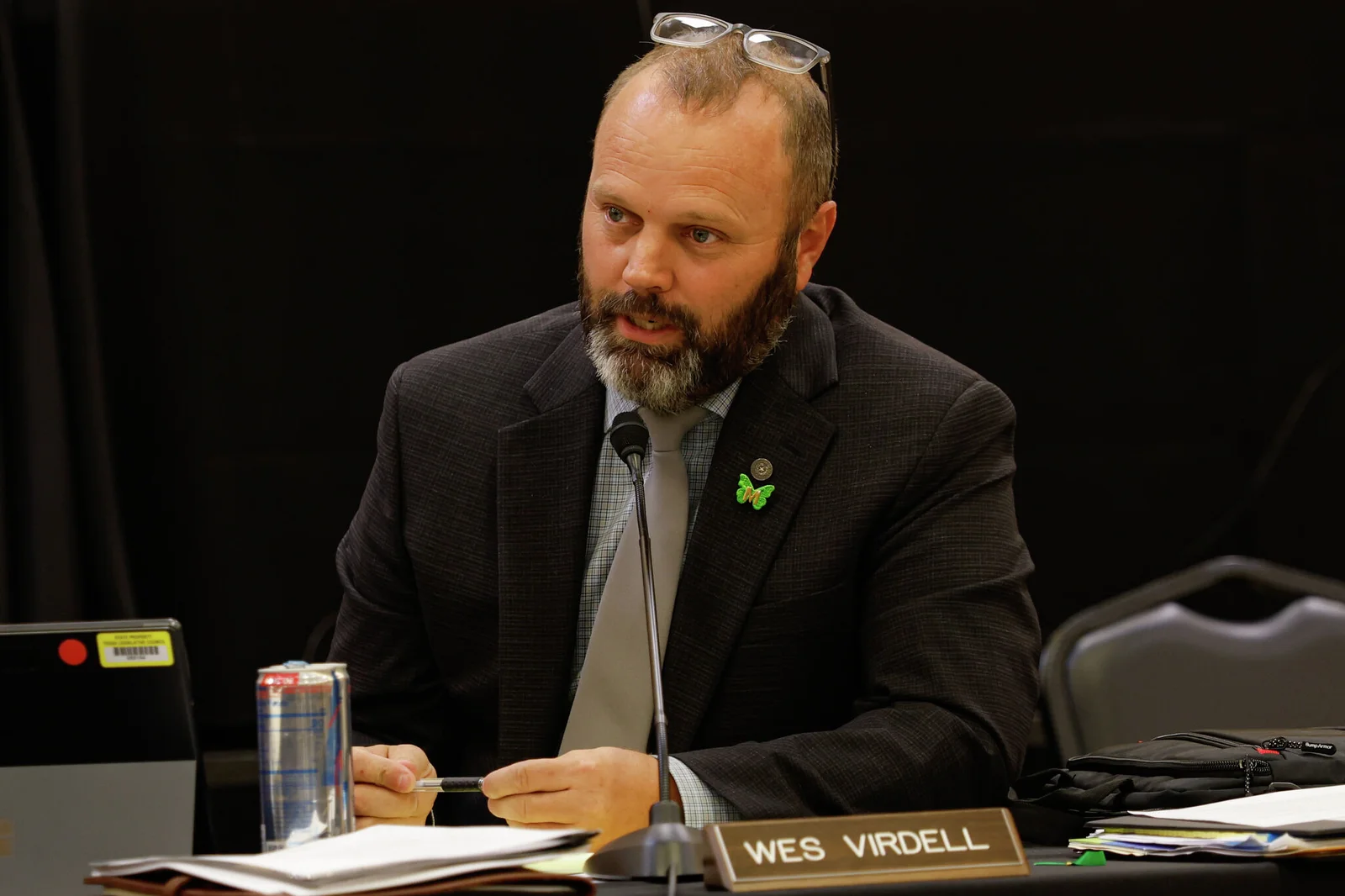 Texas state Rep. Wes Virdell speaking into a microphone at a legislative hearing desk