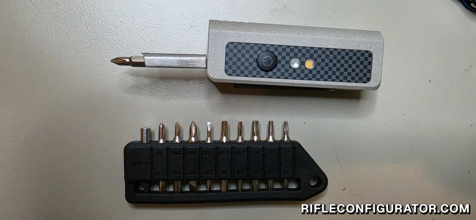 OKNIFE MK with the magnetic bit driver extended above the OKNIFE MBS1 bit set holding nine double-ended bits and a pencil insert