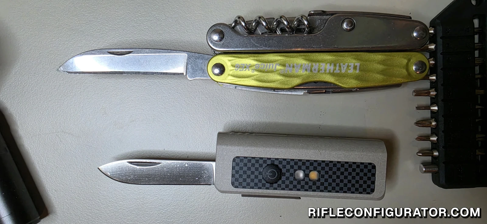 OKNIFE MK with its blade open below a Leatherman Juice XE6 with its blade open
