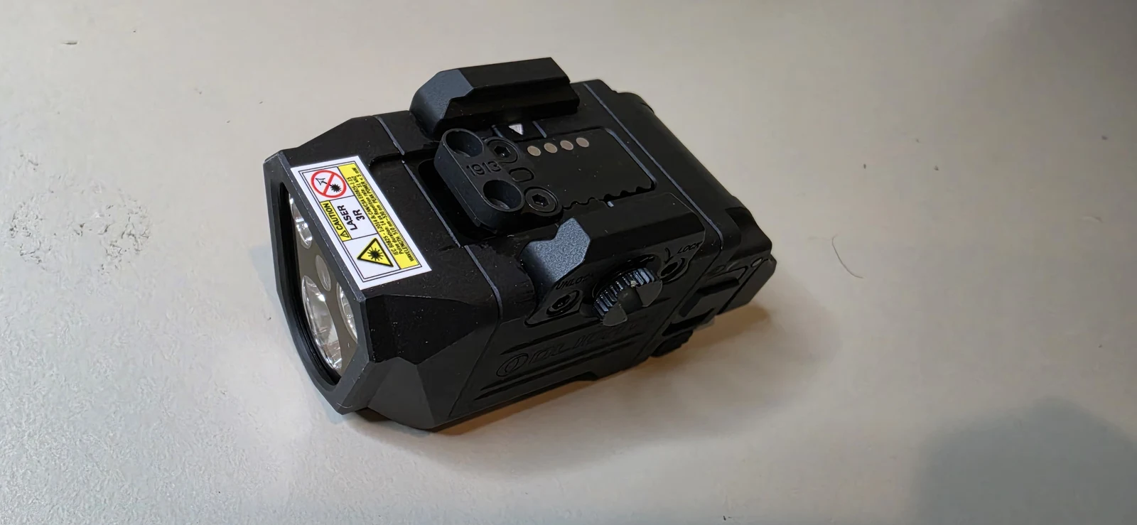 Olight PL X GL off the gun with the 1913 rail insert sitting on top of the body