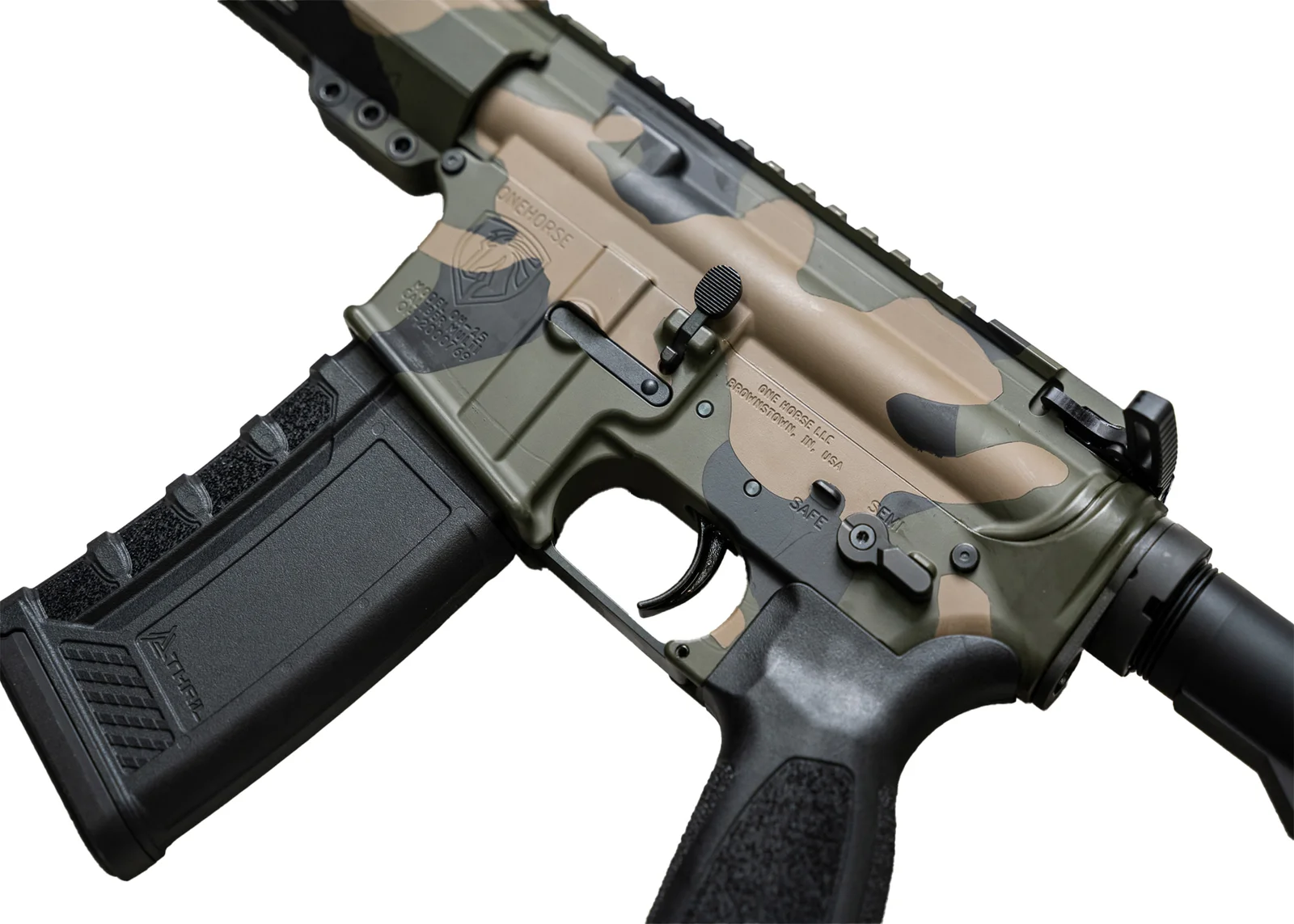 Close-up of the receiver on a One Horse Express AR-15 in Woodland Camo Cerakote finish