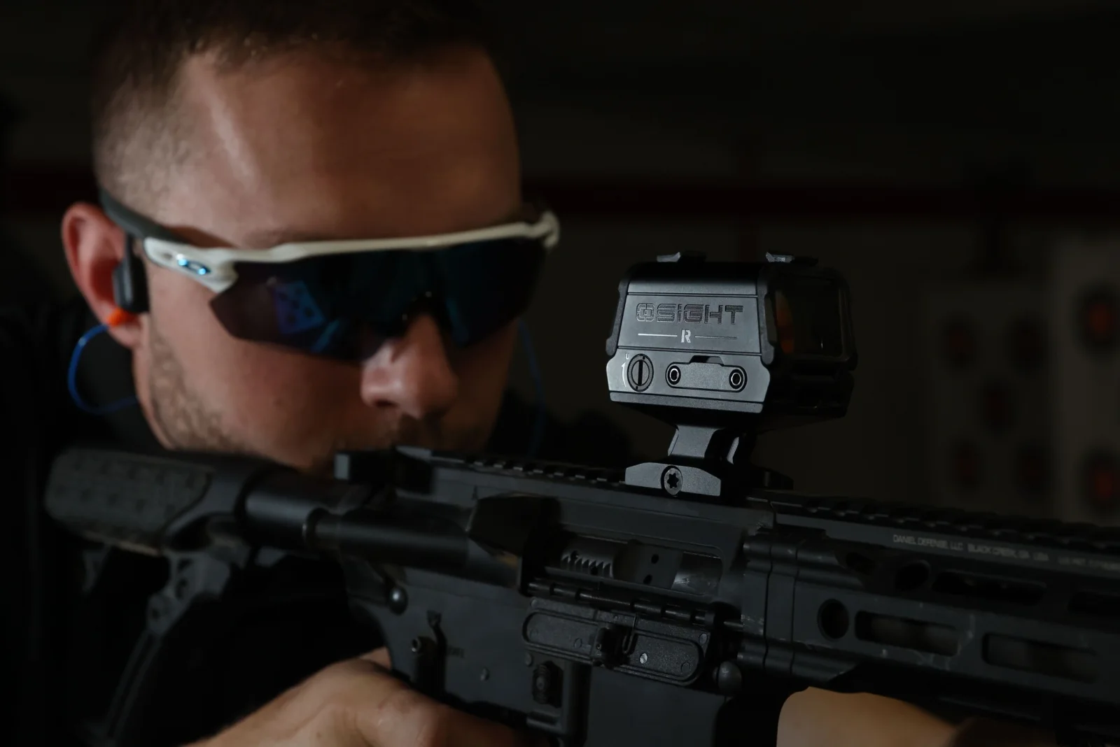 Shooter using a rifle fitted with the Osight-R on a raised mount