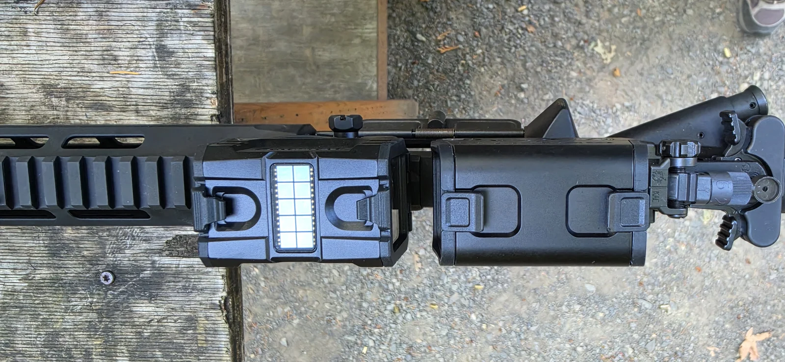 Top-down view of the Holosun AEMS Pro X2 at left with its solar panel and the Osight R at right, both with flip covers closed