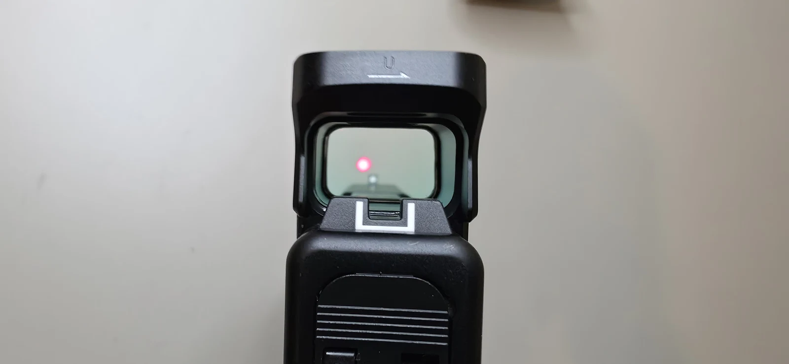 View through the Osight SE MOS window on a Glock 47, showing the red dot above the factory front sight dot with the white-outline rear notch below the glass