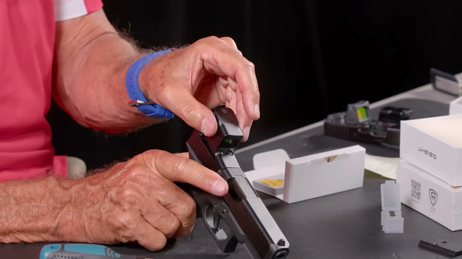 Osight SE MOS being lowered onto the optic cut of a Glock MOS slide during installation