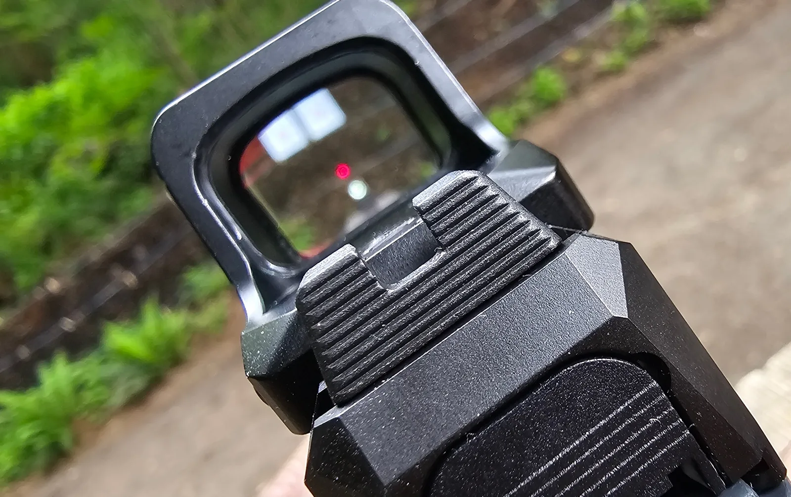 Rear view down the slide showing the XR window with the factory RXM iron sights co-witnessed underneath the dot