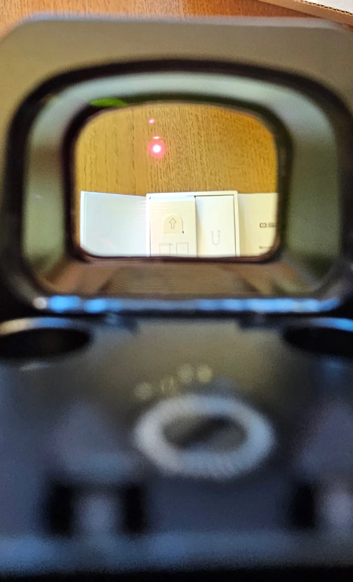 Through-the-window view of the Osight XR reticle showing the 2 MOA red dot illuminated