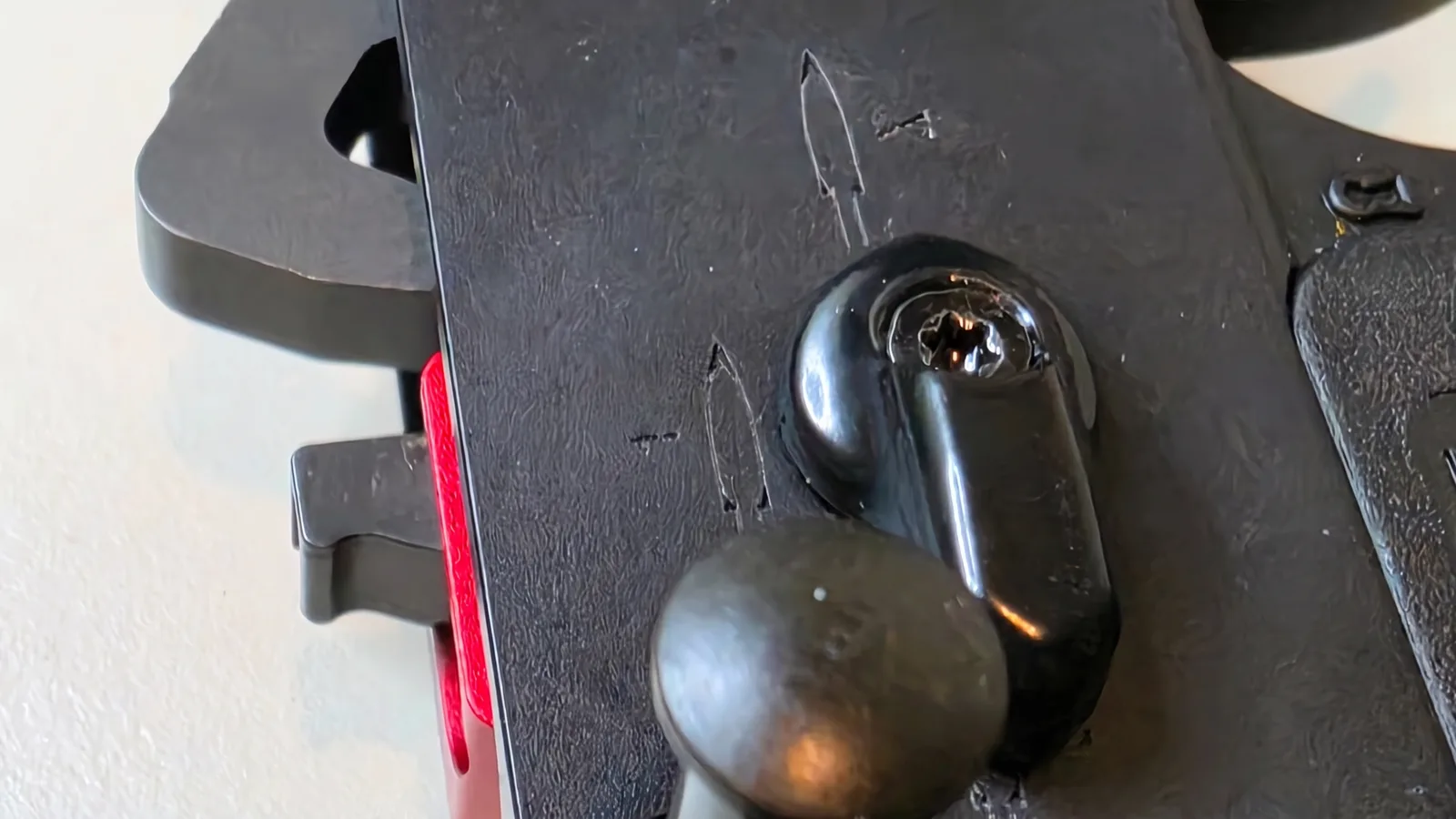 Close-up of the SBW selector lever on an AR-15 lower receiver showing the Torx screw head in the lever and the receiver's selector position markings