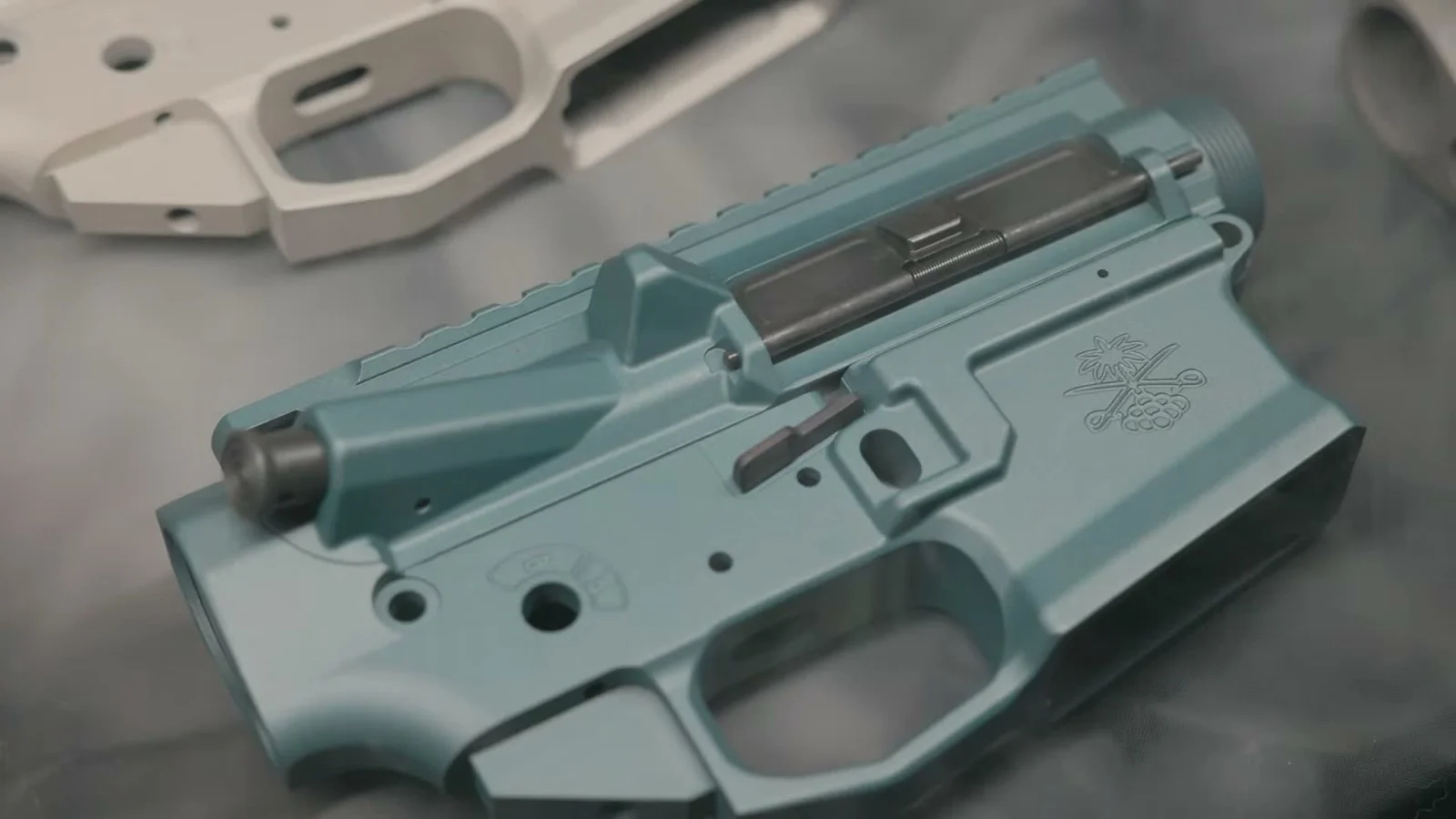 Sabre Enhanced upper in Blue Titanium with a Champagne lower in the background, lit moody with light smoke for the launch reveal
