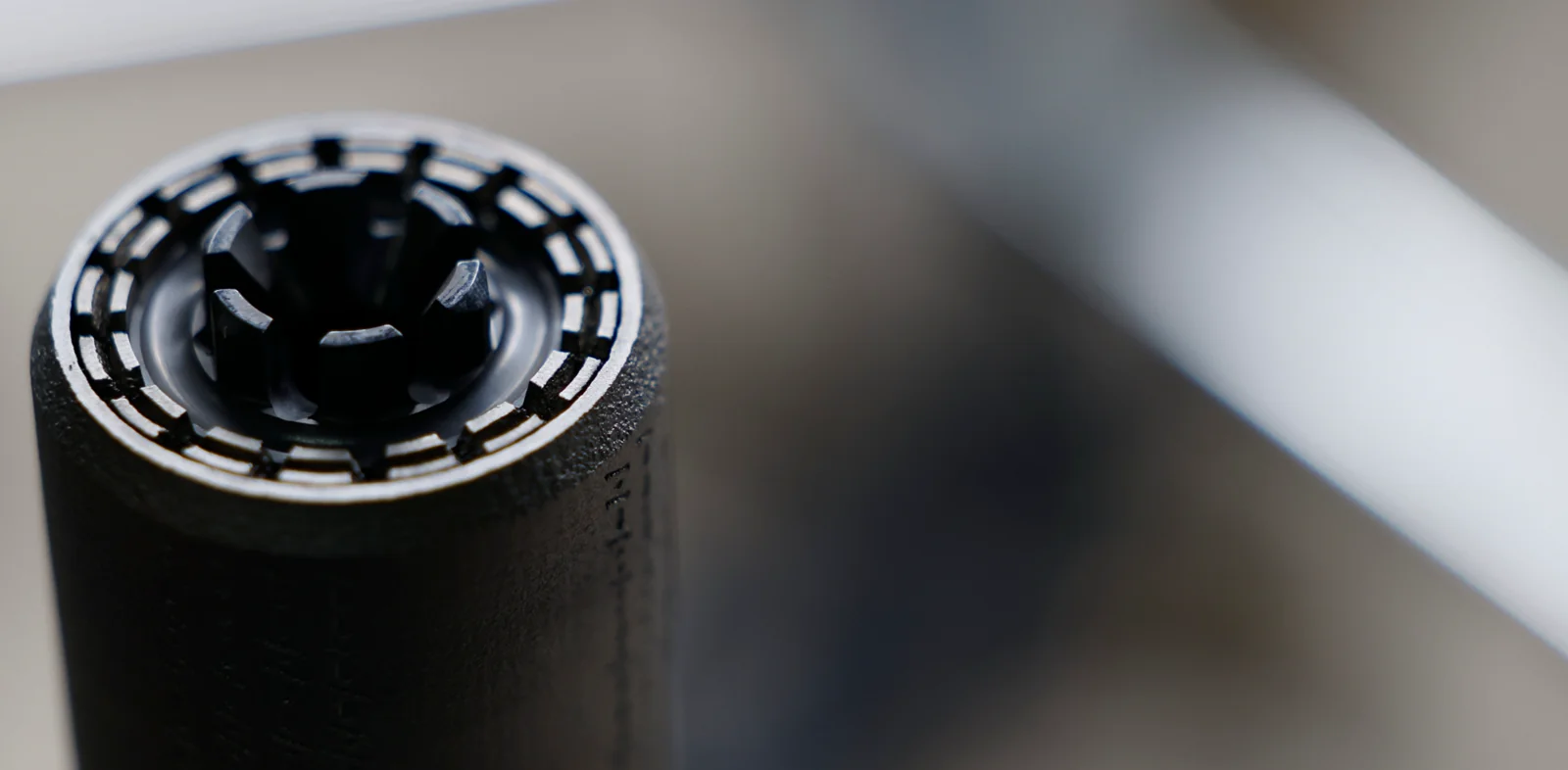Close-up of a Polite Society Huckleberry jet-turbine diffuser endcap showing concentric vent slots around the bore