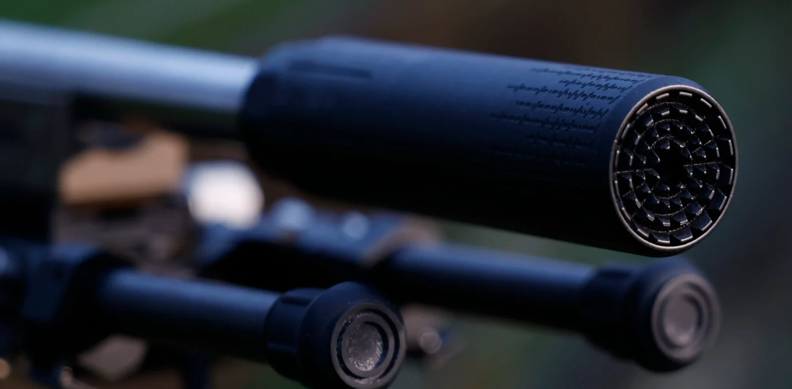 Muzzle-end view of a Polite Society Verdict 7.62 suppressor showing the jet-turbine diffuser endcap on a stainless barrel