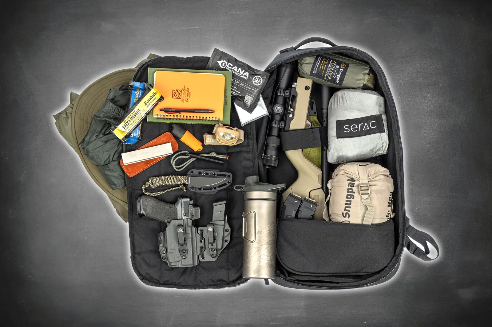 Ruger 10/22 Takedown rifle disassembled and packed in a survival backpack alongside a handgun, knife, and emergency supplies