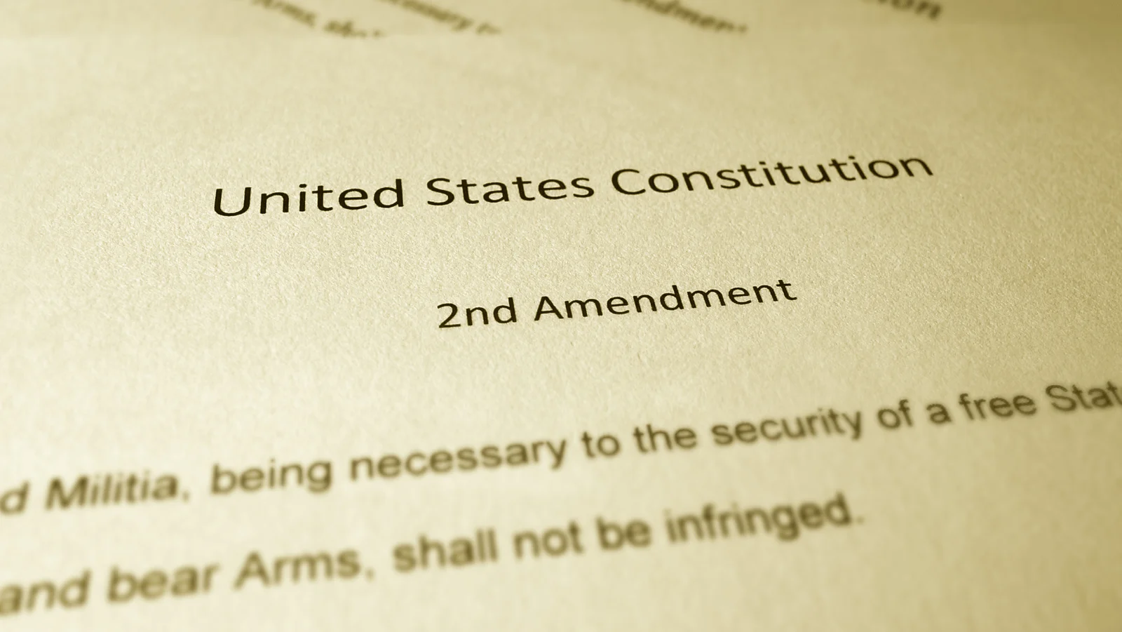 A printed document showing the text of the United States Constitution and Second Amendment.