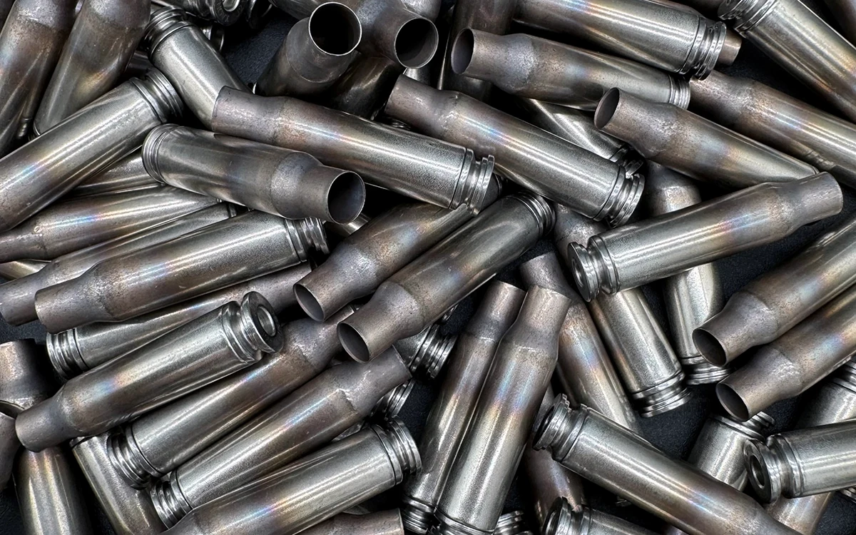 Loose pile of Shell Shock NAS3 .308 Winchester / 7.62x51mm nickel-alloy cartridge cases