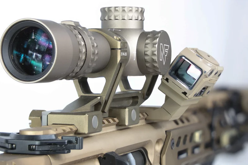 AR-15 with a magnified scope and an offset red dot demonstrating the offset mounting concept