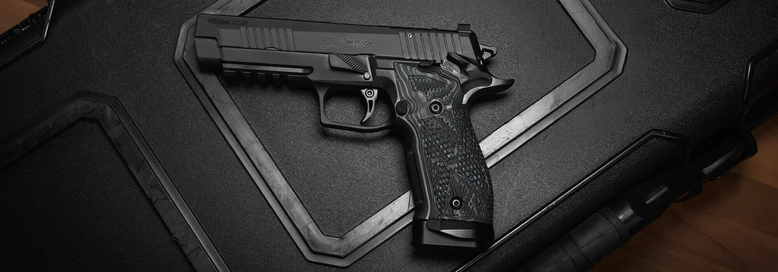 SIG P226-XFIVE Extreme Nitron XSeries pistol with G10 grips and optic-ready slide resting on a pistol case