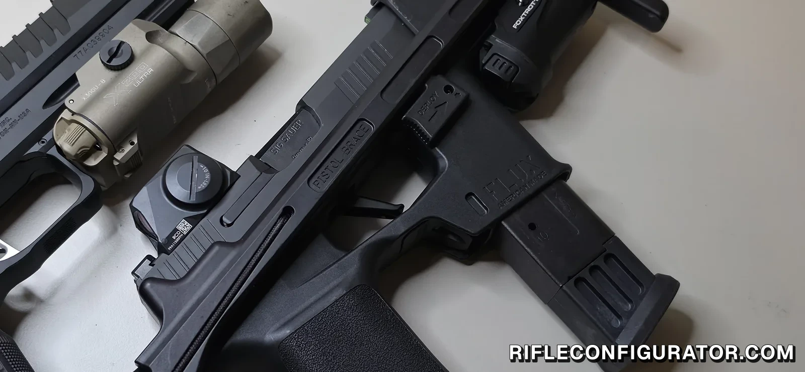 Close-up of a SIG P365 in a Flux Raider chassis showing the marked brace deploy button and a FOXTROT1X light mounted forward, with a SIG P211-GTO and its SureFire X300U-B at left for scale