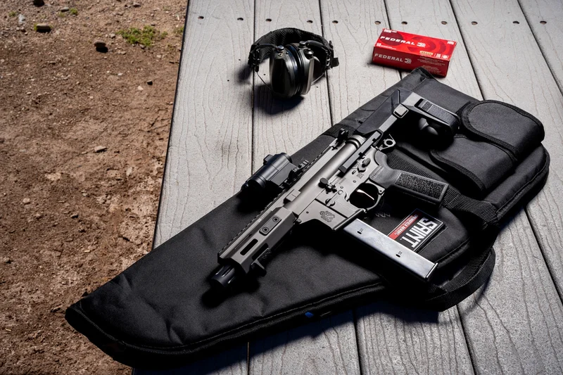 The Springfield SAINT Victor 9mm PDW on a range bench with Federal 9mm ammunition and hearing protection