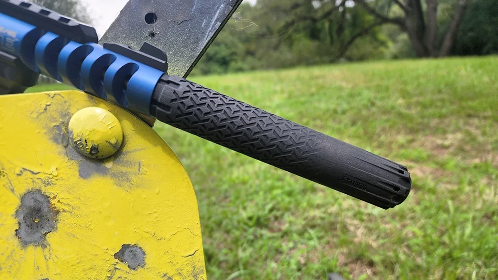 Taurus TTX22 suppressor threaded onto a Ruger 22/45 Lite, showing the Taurus roll mark and textured titanium tube