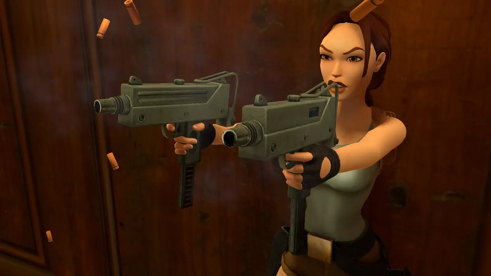 Lara firing both remastered MAC-10-style Uzis at a cultist in Tomb Raider II