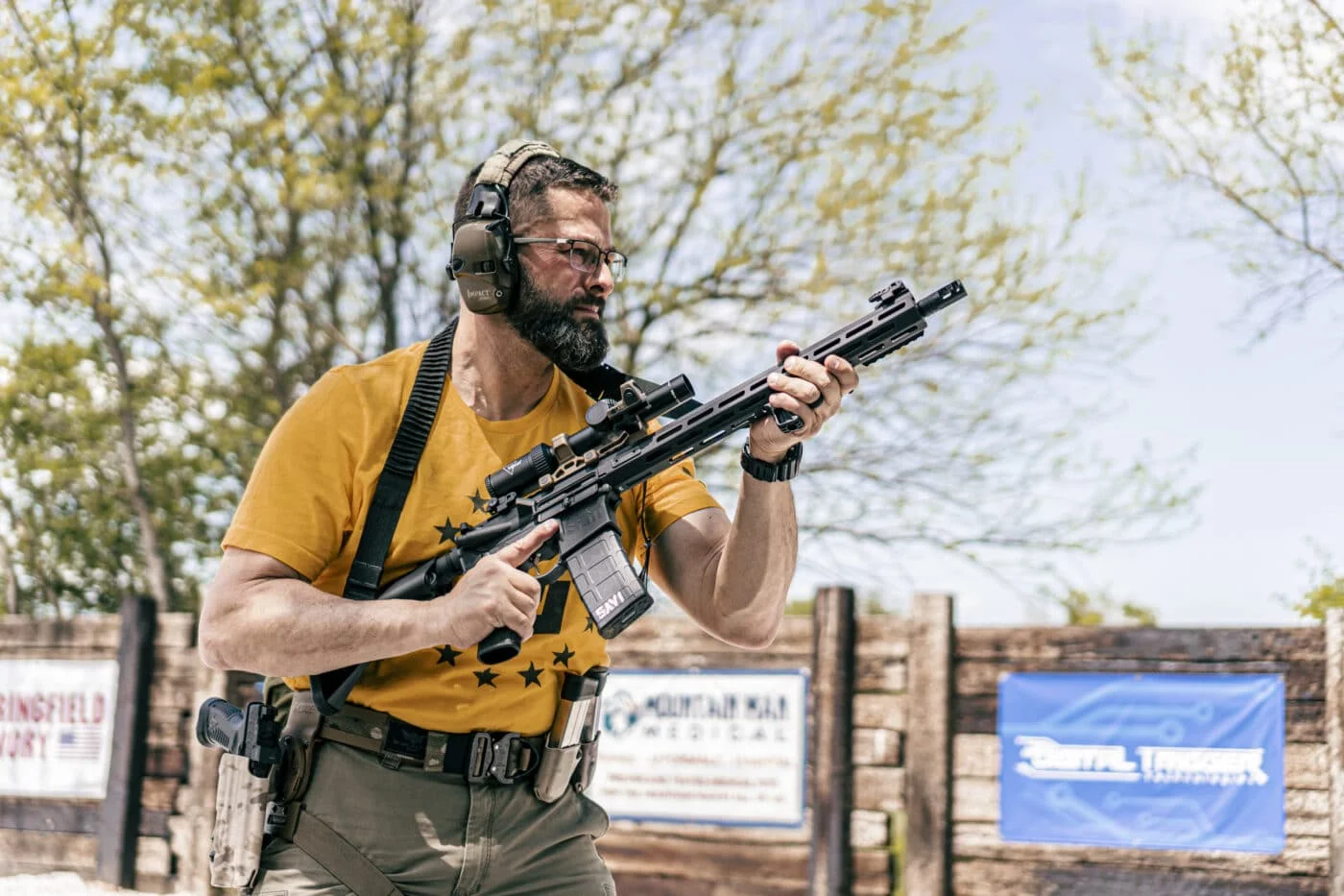 Shooter running an AR-15 rifle at the range during a fast follow-up shot drill