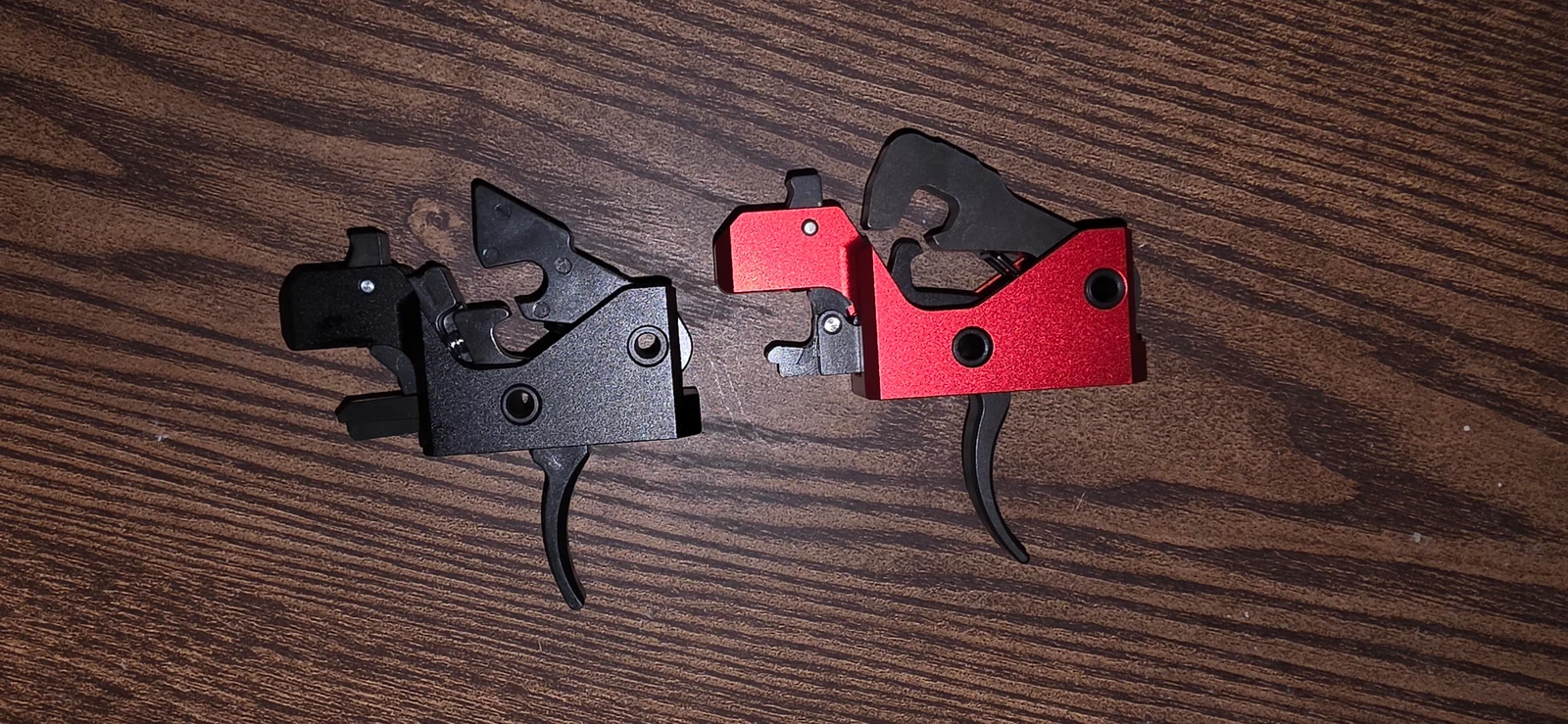 The Triggered Company Disruptor and LAT drop-in trigger cassettes side by side on a wood table