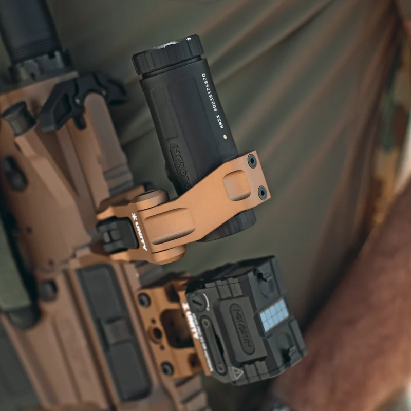 Close-up of the Unity Tactical FAST FTC Holosun mount stowed below the sight plane showing the flip-to-center geometry inside the receiver footprint.