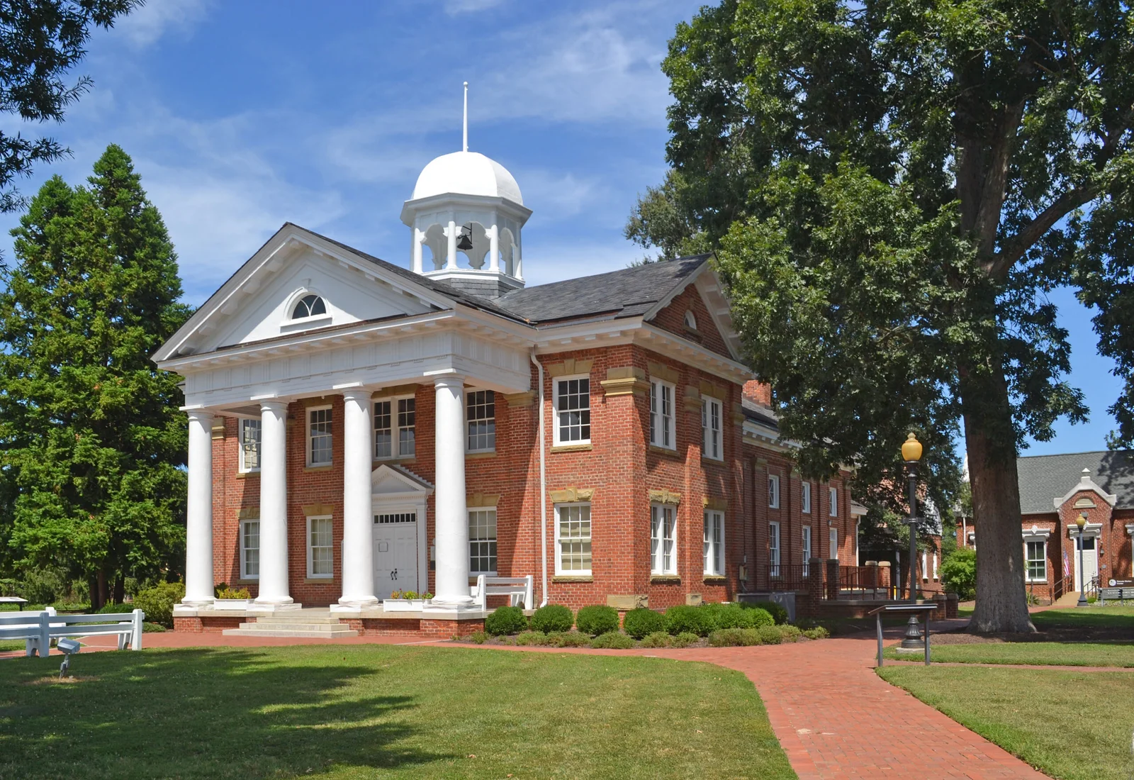 A red brick Virginia circuit courthouse with white columns and a domed cupola