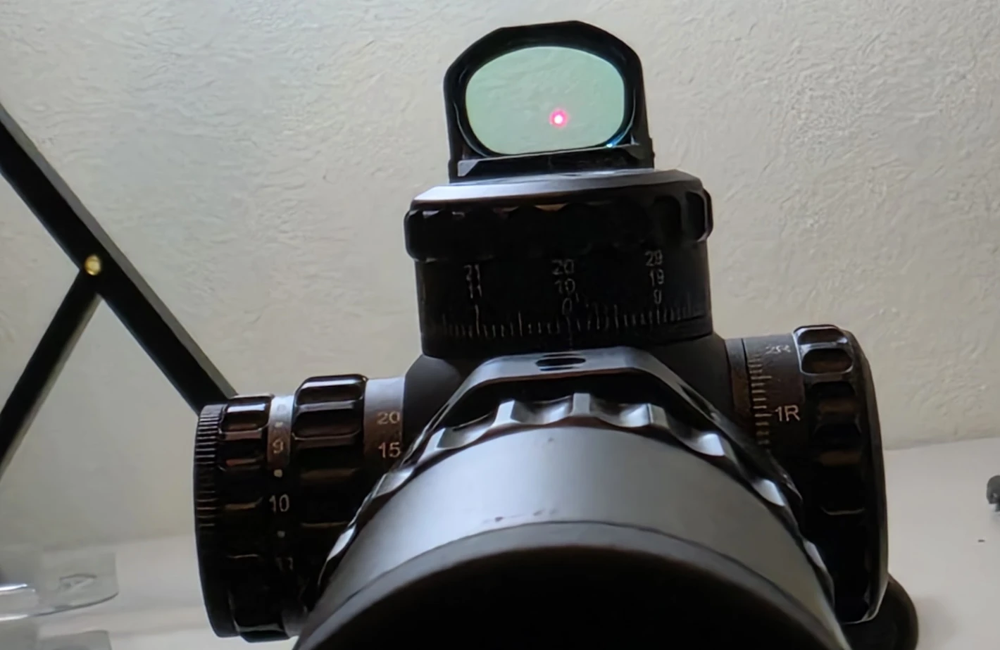 The Vector Optics Frenzy FM red dot lit on top of the Continental 2-12x44 scope ring, the red dot visible in the window above the elevation turret