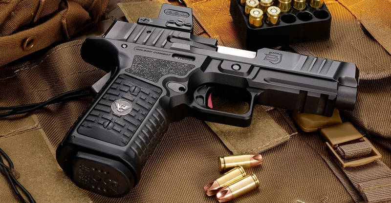 Wilson Combat BULWARK 9mm pistol profile view with mounted red dot optic on tan tactical gear