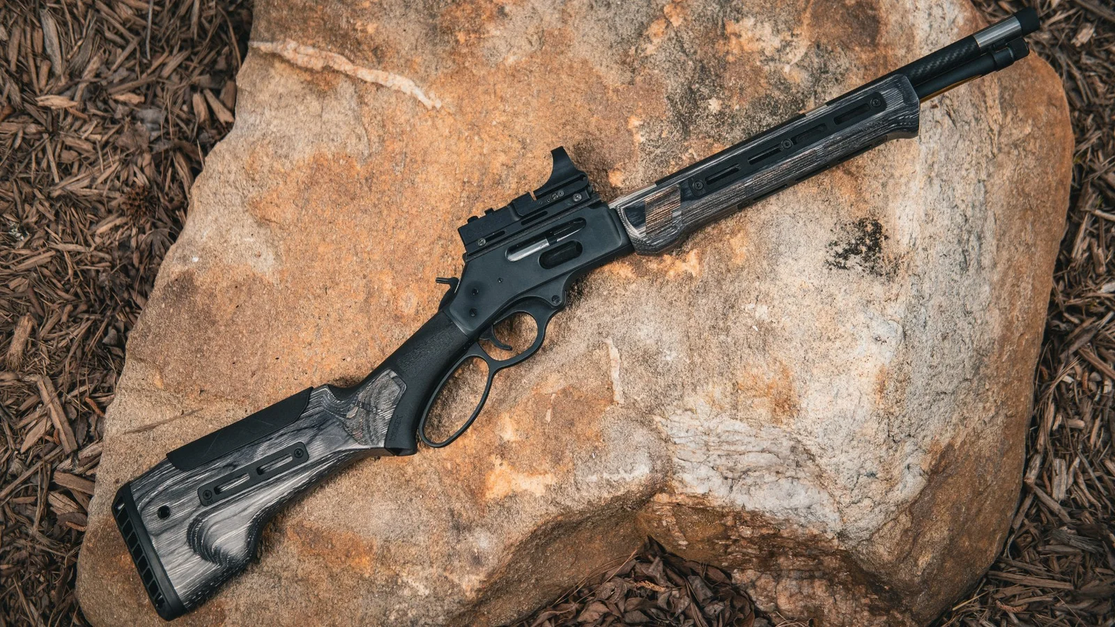 WOOX Bravado Grey Laminate stock on a Marlin lever-action rifle, showing the five-position cheek riser, M-LOK slot, and ambidextrous palm swell