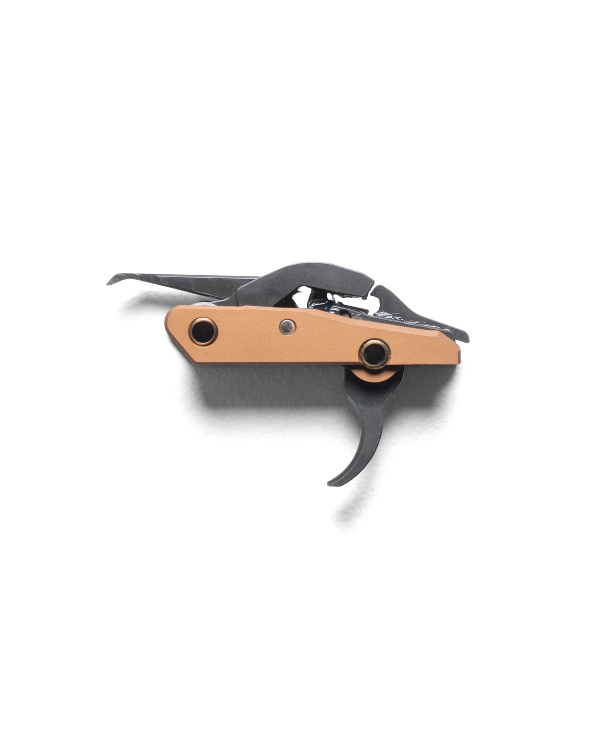 Side profile of The Wrangeler AK trigger cassette showing the trigger, hammer, and copper side plate