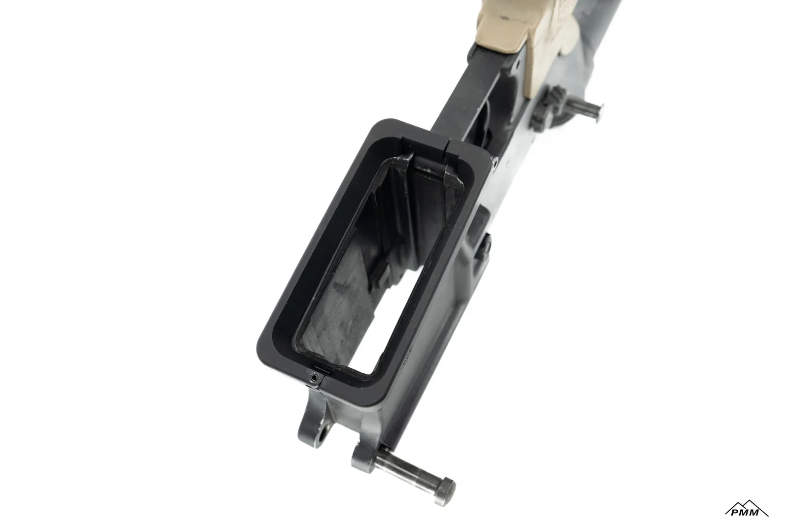 Standard forged mil-spec AR-15 lower receiver showing the unflared magazine well opening and the trigger-guard tabs the X-Flare bolts to