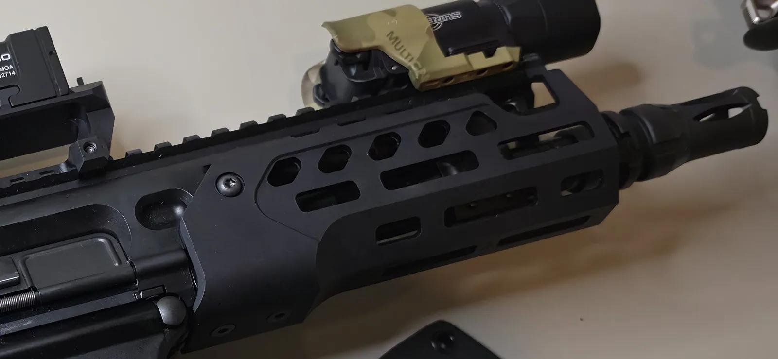 SIG MCX Rattler LT upper in .300 Blackout showing its short barrel, muzzle device, and M-LOK handguard, with a SureFire X300 mounted forward and an Aimpoint Acro P-2 at the rear
