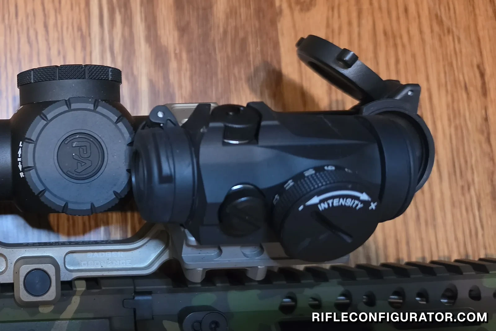 Aimpoint Micro T2 on an FDE Badger Ordnance mount next to a Primary Arms ACSS Raptor scope on a camo AR-15