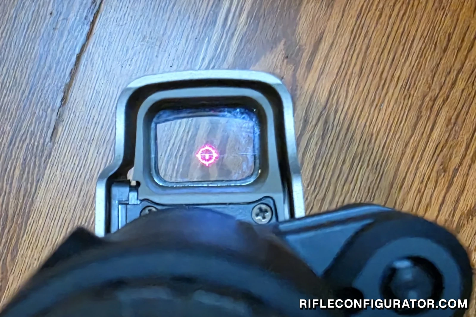 The EOTech EXPS3 holographic reticle glowing red, photographed through the sight window