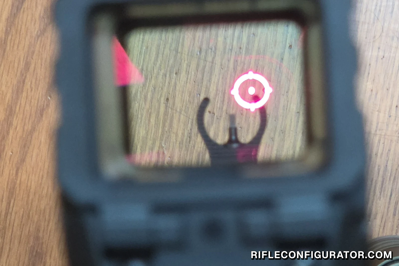 Looking through the Holosun AEMS Pro X2 window at the lit circle-dot reticle, with the front sight post co-witnessed below it