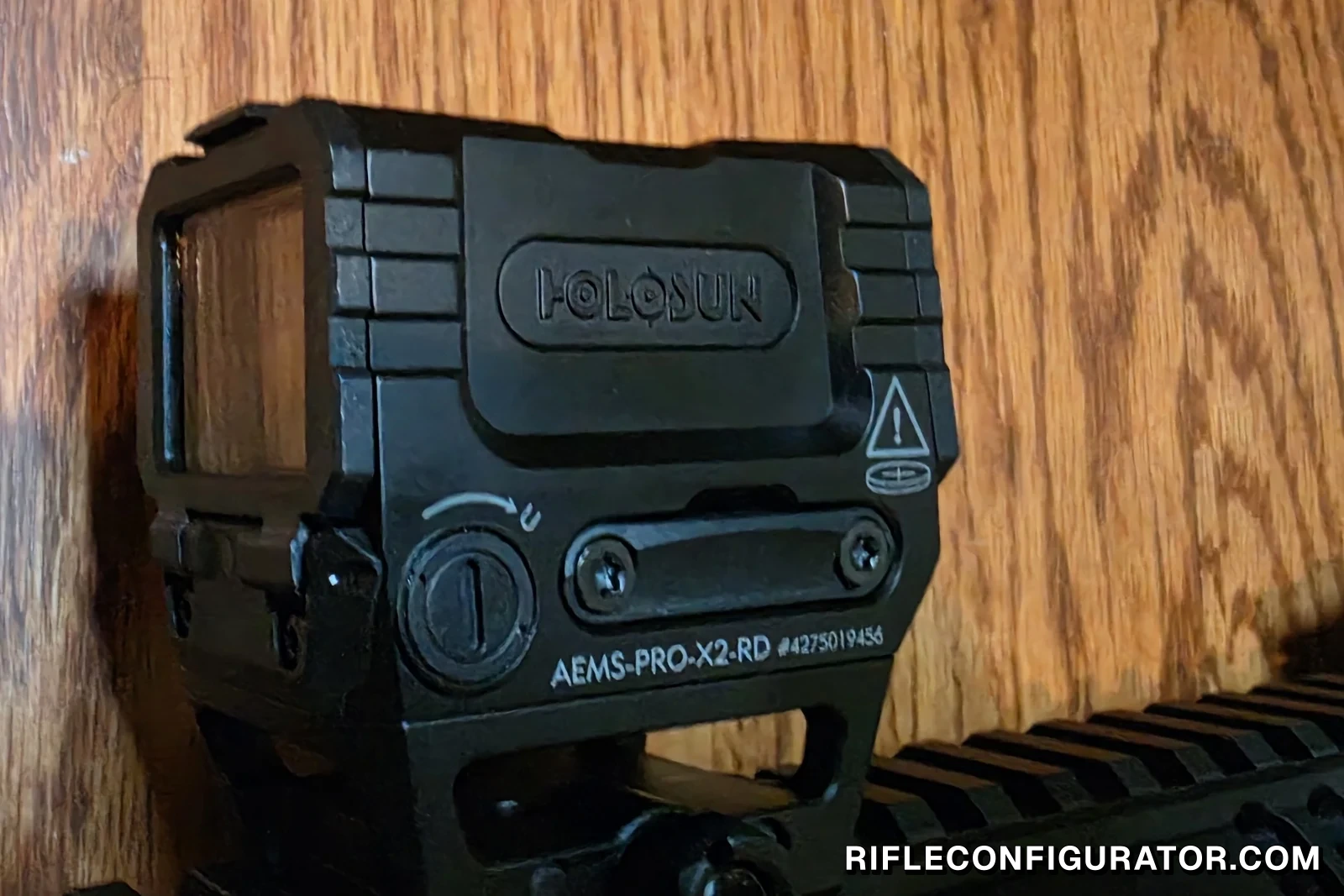 Holosun AEMS Pro X2 enclosed emitter red dot mounted on an AR-15 rail, with the AEMS-PRO-X2-RD model engraving visible