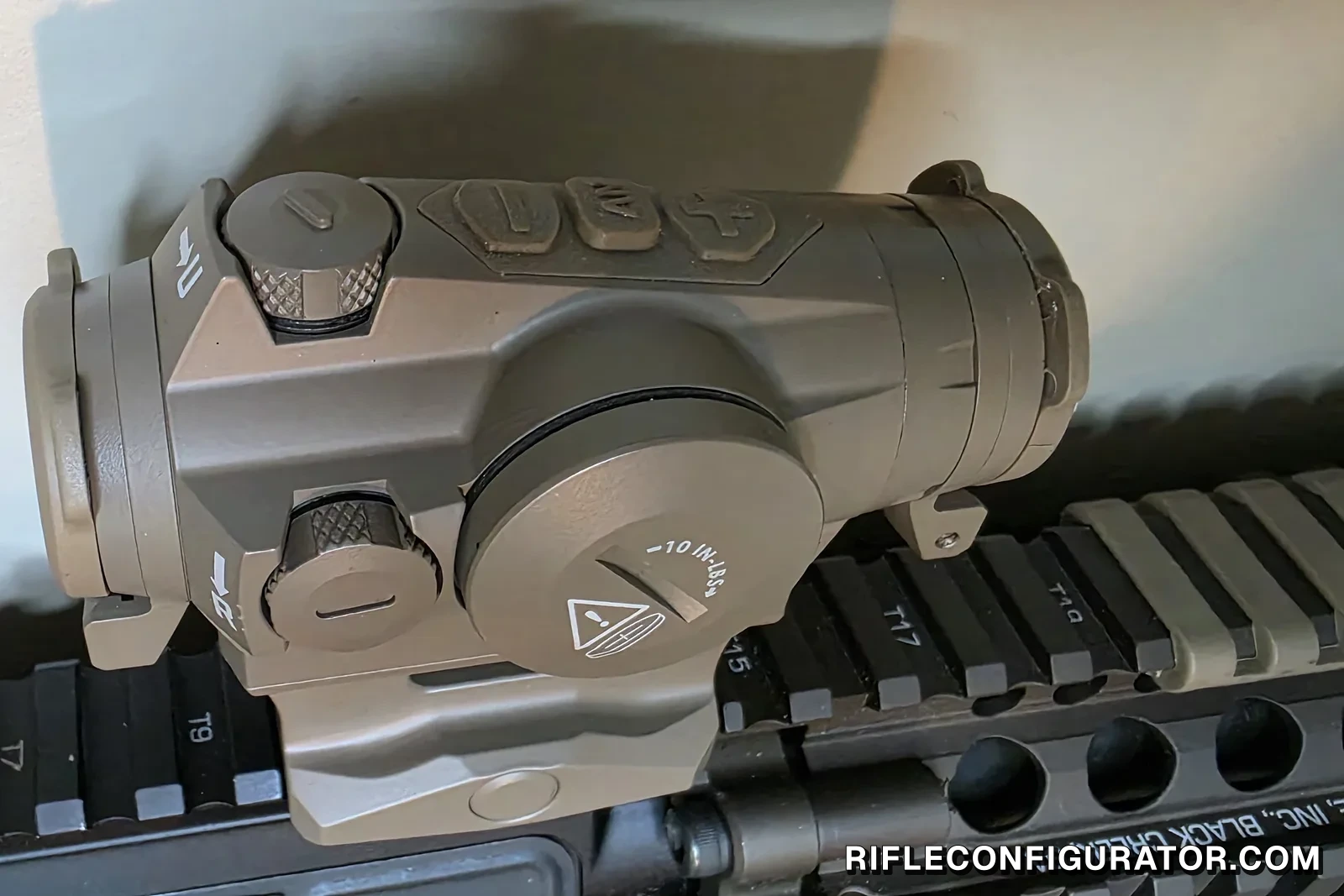 FDE Sig Romeo 4T Pro mounted on a Daniel Defense quad rail, showing the battery cap, brightness buttons and turrets