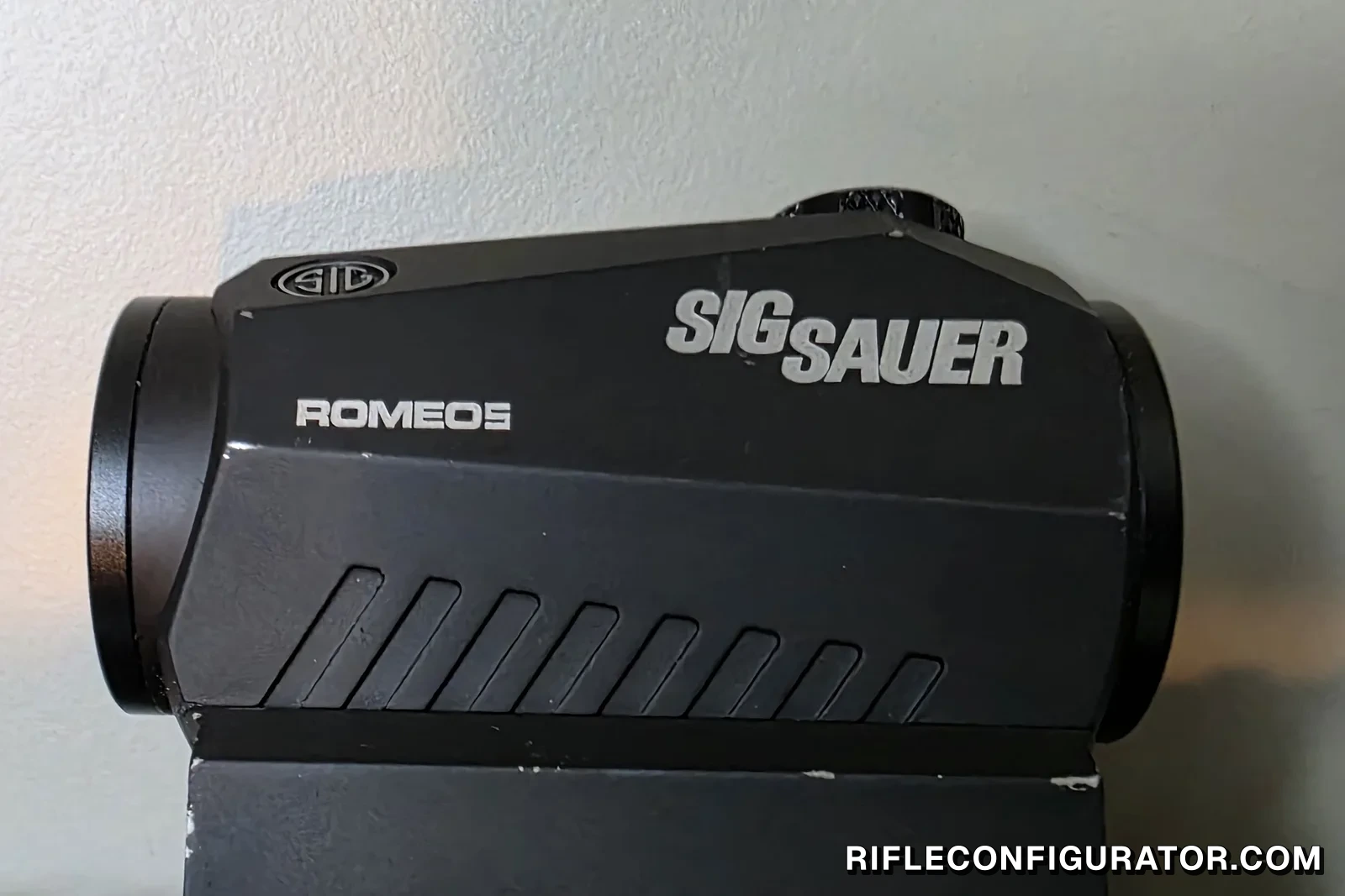 First-generation Sig Sauer Romeo 5 red dot with the SIG SAUER and ROMEO5 markings visible on the housing