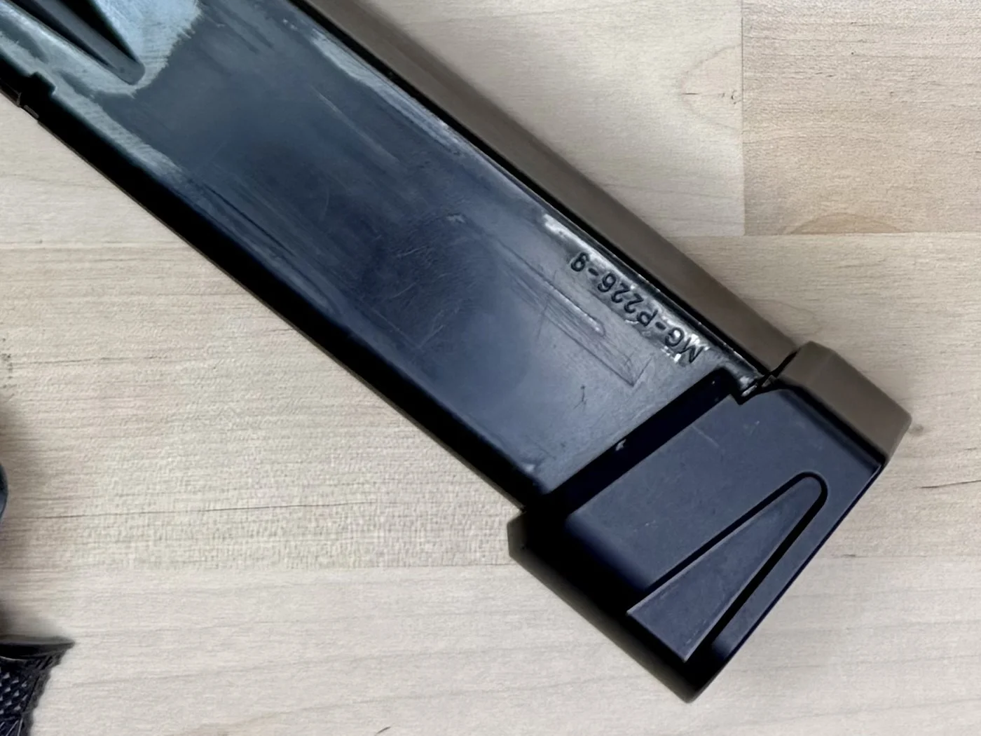 Cascade Range Systems Comp Basepad on a Mec-Gar P226 magazine stamped MG-P226-9, showing the angled side ledge used to strip a stuck magazine