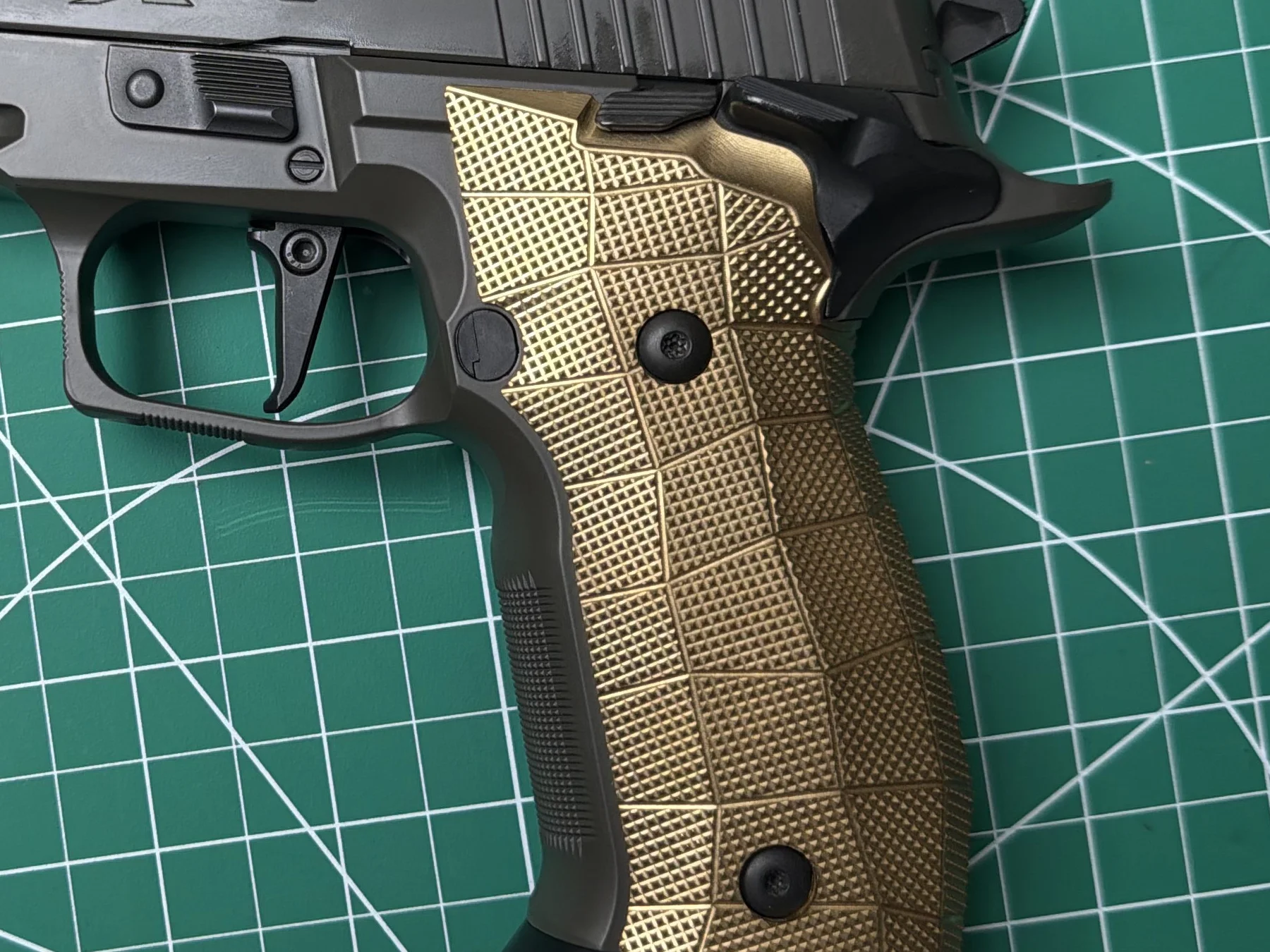 LOK GridLOK brass grip panels on a friend's P226 XFive Legion frame, showing the GridLOK texture behind the flat trigger and SAO safety